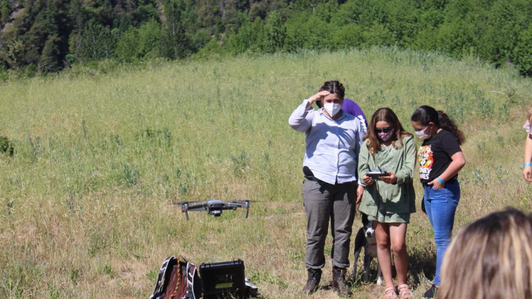 University of Washington graduate student shows students how to fly a drone for native/invasive plant population mapping.